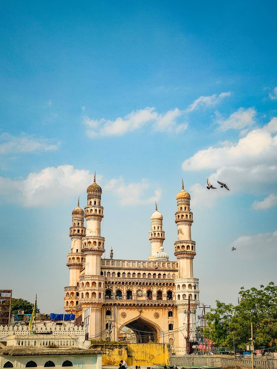 The four minarets of the Charminar monument in Hyderabad under a blue sky